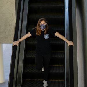woman in black t-shirt and black pants standing on stairs