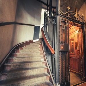 a staircase with a wrought iron door and railing